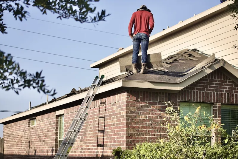 Professional roofer working on a residential roof in Windhover